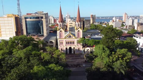 aerial drone view of a cathedral church surrounded by urban buildings in posadas city of argentina