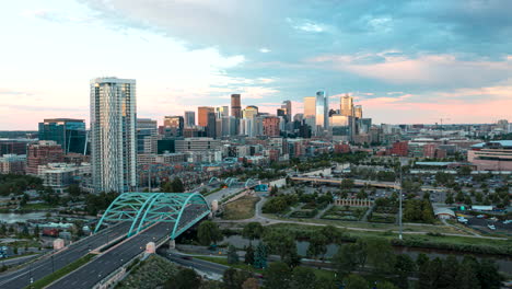 Aerial-hyperlapse-of-Denver,-Colorado-with-traffic-streaming-into-the-city-on-Interstate-25