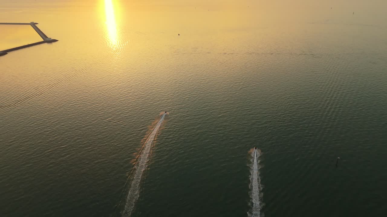 Stunning 4K drone footage of two speedboats slicing through golden waters at sunset off the Kuwait coast. Ideal for travel, nature, lifestyle, and cinematic projects.