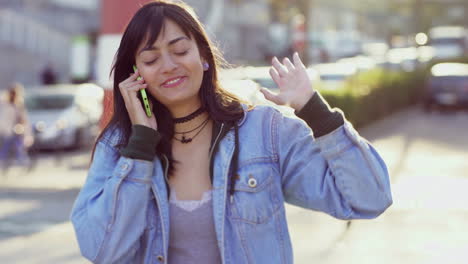 excited teenage girl talking on smartphone while strolling on street.