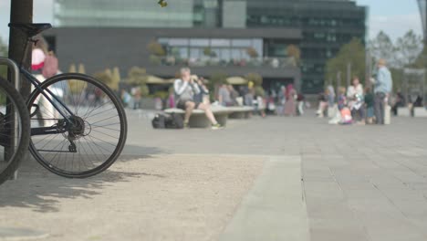 Tourists-And-Office-Workers-Sitting-Outdoors-In-Coal-Drops-Yard-In-Kings-Cross-District-In-London-UK