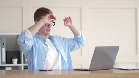 man stretching at his desk