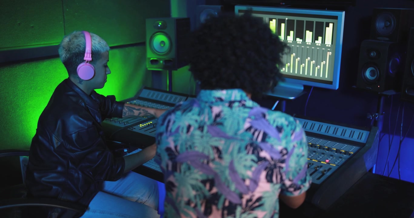 Creative People Working on Music Production in a Modern Recording Studio