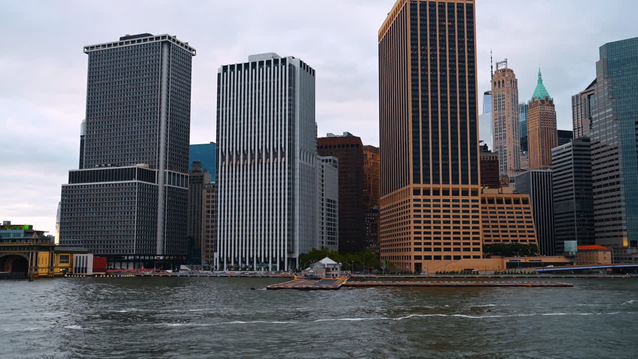 Modern office buildings in Lower Manhattan from the water. Close view of 55 Water Street and neighboring skyscrapers in New York City's financial hub