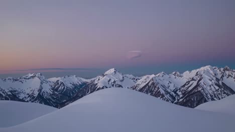 heart-shaped cloud over snowy mountain peaks at sunrise/sunset