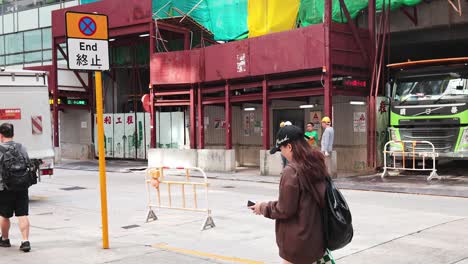 pedestrians pass by a construction site