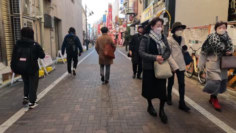 pedestrians crossing and walking along a busy street