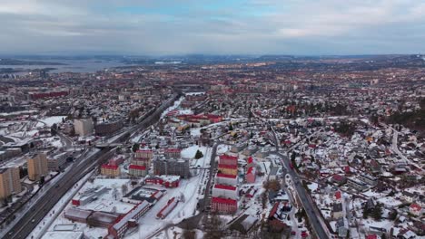 linderudkollen oslo fjord norge norway aerial drone gamle tonsengagen bjerke arvoll morning buildings cars traffic highway roads snowing cold cloudy winter day gray skies forward pan up