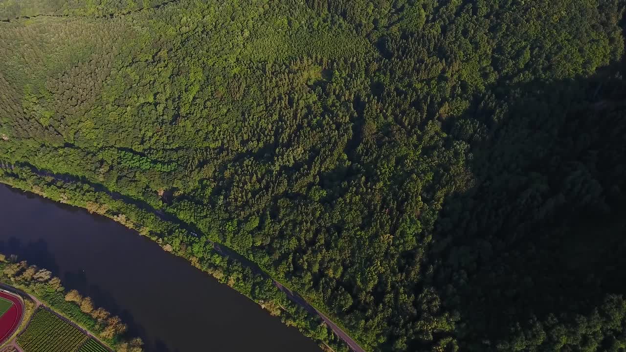 High flying drone aerial view of a forest overgrown hill bird eye