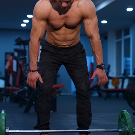 muscle athlete strongman walks in a gym after heavy training. perfect torso with strong abs. handsome power male with naked torso