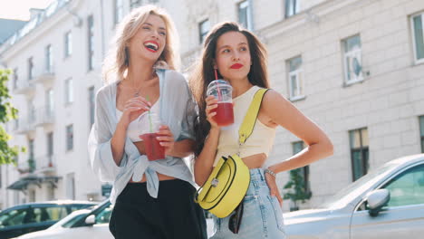 two friends enjoying drinks in the city