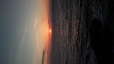 vertical sunrise over the cornish atlantic ocean in cornwall from an aerial drone