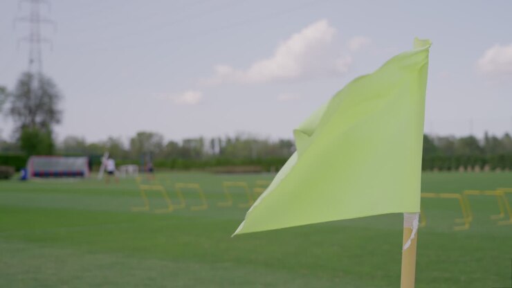 Waving flag in slow motion shot on soccer training grounds