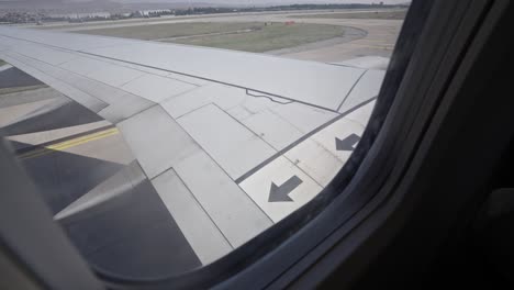 Airplane reversing on runway, getting ready for take-off at airport