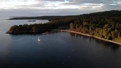 aerial view of orcas island coastline at sunset with sailboat luxury yacht moored.san juan islands in washington pacific northwest