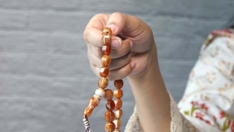 woman holding prayer beads