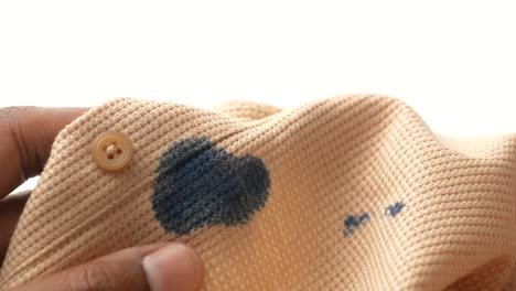 close-up of a stained beige shirt with a button