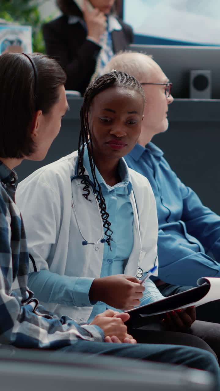 Doctor consulting with patients in a hospital waiting room