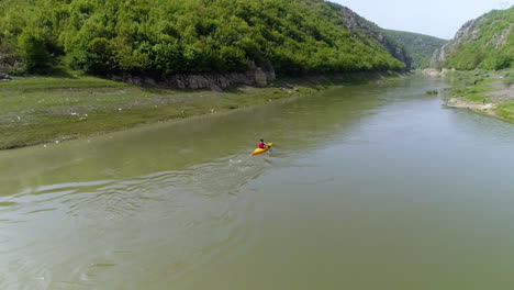 kayaking aerial tracking shot paddling through drin river canyon in kosovo