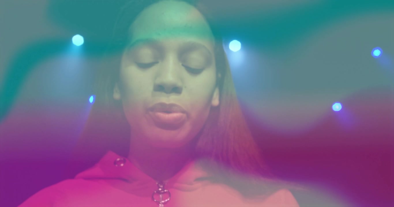 Female teen receiving camera pan and speaking with pulsing teal magenta overlay for music branding