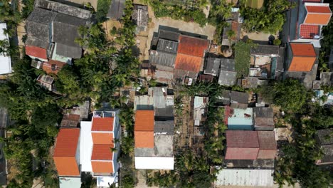 top down drone flight over typical slum housing in south east asia with people