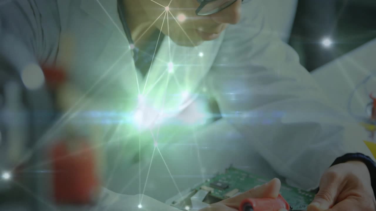 Electronics engineer probing and soldering PCB as network overlay highlights voltage