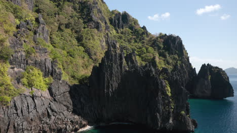 aerial showing rocks and cliff edge on matinloc island, el nido, palawan, pilippines