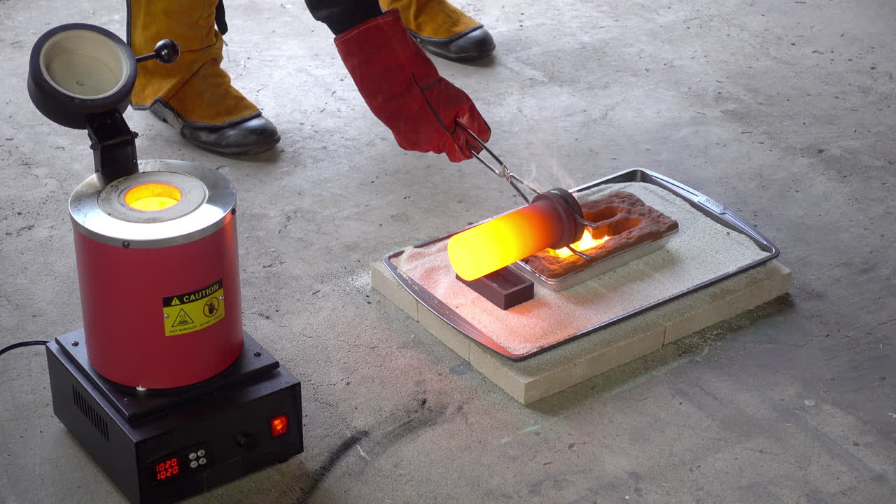 Crucible is removed from furnace, molten metal poured into molds, and crucible replaced in furnace