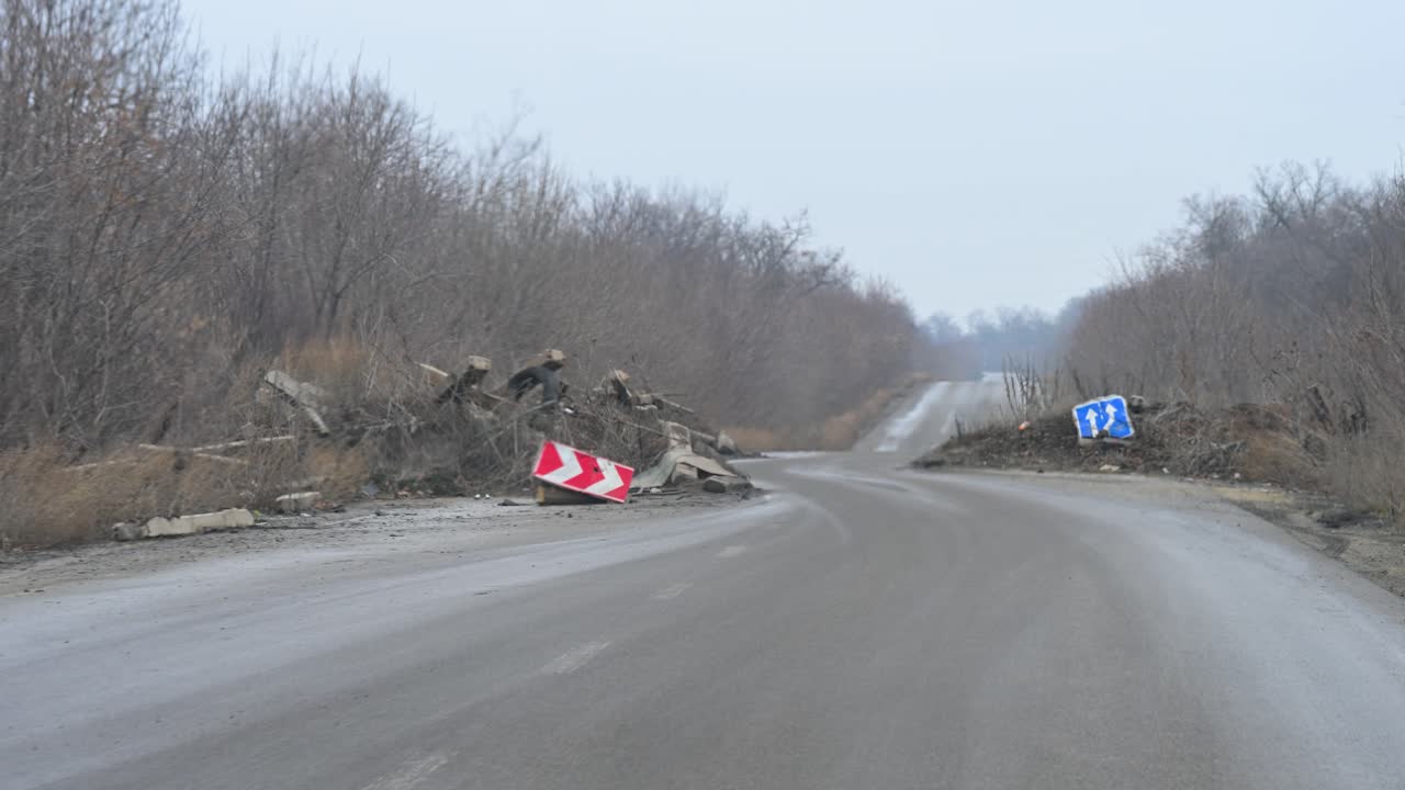 A point-of-view shot from a car driving past a makeshift military checkpoint on the outskirts of Kramatorsk, Ukraine. A common sight on roads near the frontline