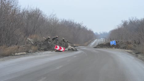 a point-of-view shot from a car driving past a makeshift military checkpoint on the outskirts of kramatorsk, ukraine. a common sight on roads near the frontline