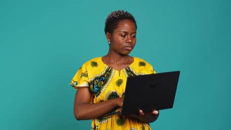 young woman freelancer navigating on online webpages in studio
