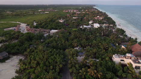 Aerial-drone-push-in-establishing-shot-of-hotels-and-main-road-in-Tulum-Mexico