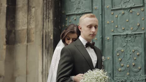 newlyweds, caucasian groom with bride walking, embracing, hugs in city, wedding couple in love