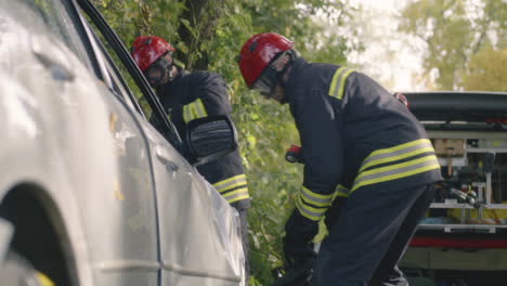firefighters rescuing people from a car accident