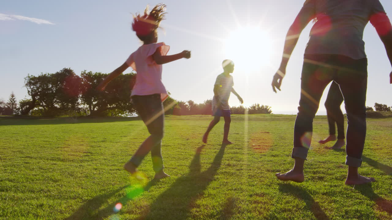 joven familia negra jugando en un campo en verano