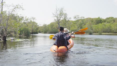 couple kayaking in a scenic landscape