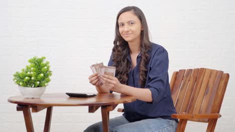 Happy-Indian-girl-counting-money