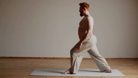 man practicing yoga pose on mat