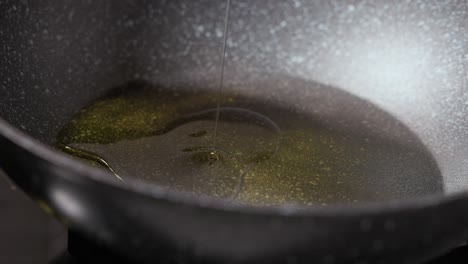 pouring oil on a non-stick pan