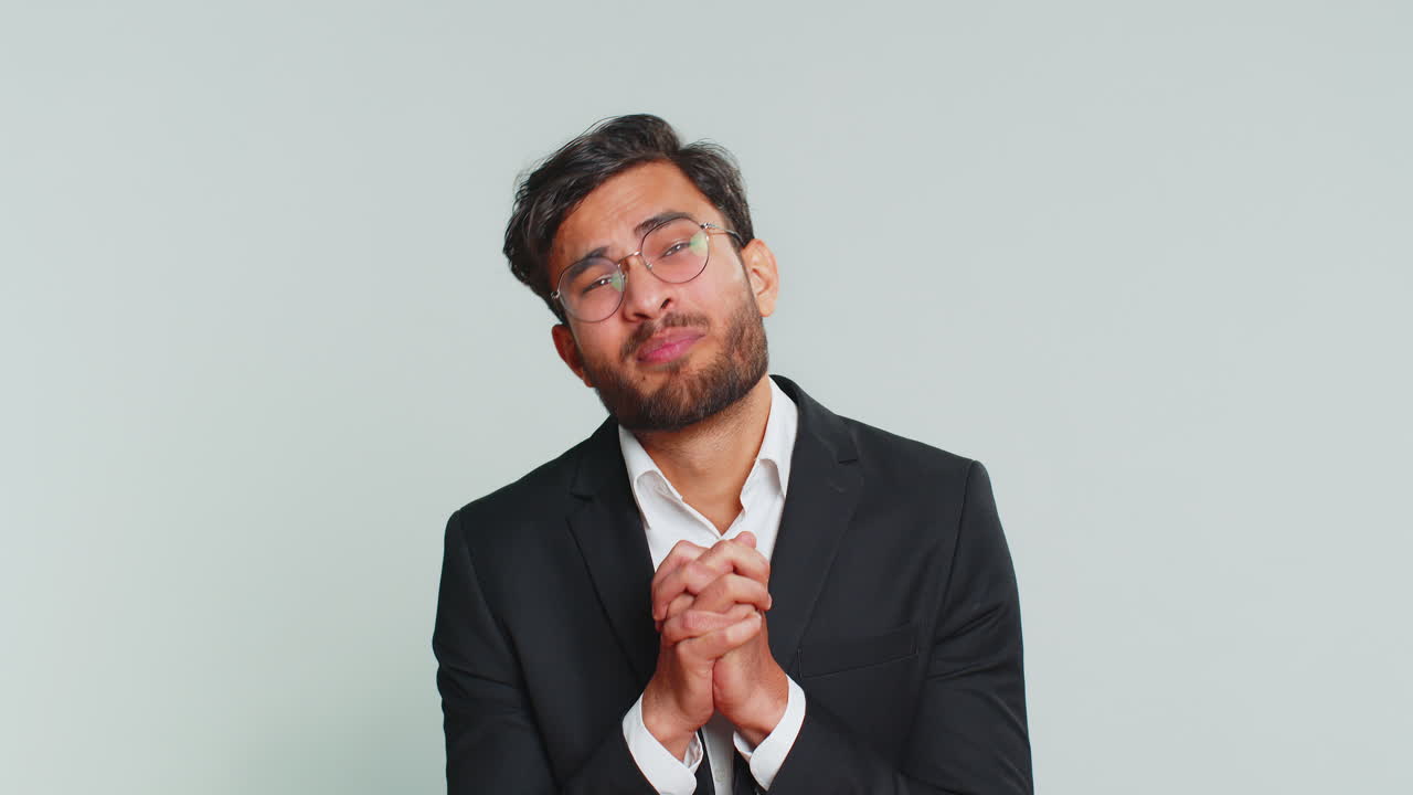 Indian business man praying making wish asking hopeful help begging apology meditation imploring