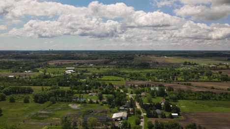 hyper lapse, time lapse of farms with clouds passing over head with a scenery landscape, forwarding aerial shot