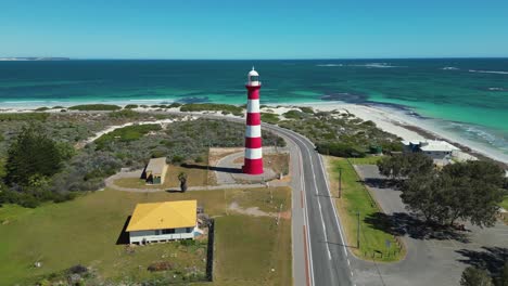 red and white lighthouse on stunning turquoise coastline