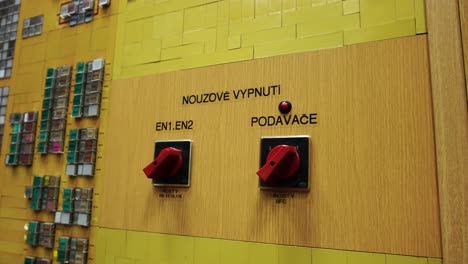 indoor power plant control room with button panel on wall with writings