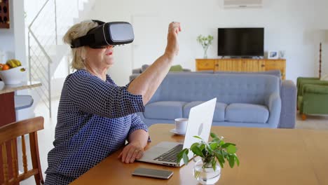 Senior-woman-using-virtual-reality-headset-at-home-4k