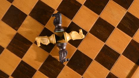 chess knights knocked down on chessboard