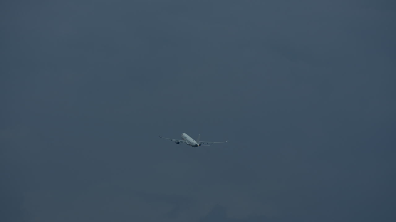 An aircraft in the grey sky