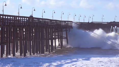 huge waves crash on a california beach and pier during a very large storm event 3