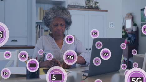 Animación-De-Tecnología-5g-Sobre-Una-Mujer-Que-Trabaja-Con-Una-Computadora-Portátil-En-Su-Oficina-En-Casa