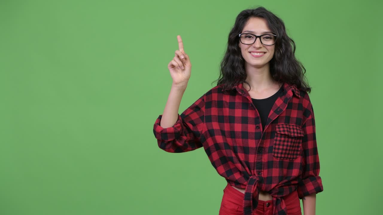 Happy young beautiful hipster woman thinking and pointing up