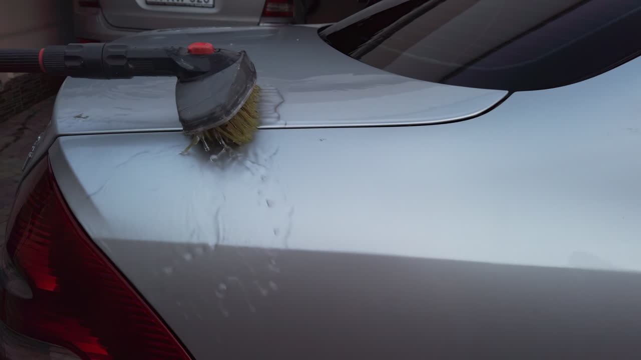 A mobile car cleaning service showcases their effective washing techniques. Attention is given to the exterior surfaces, ensuring a thorough clean with specialized tools